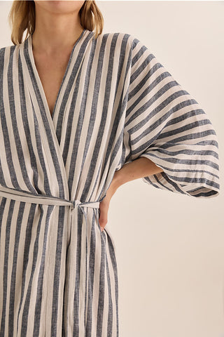 Striped robe worn by a person on a beige background
