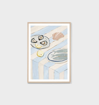 Framed artwork with a coastal theme featuring shells and a plate on a white background