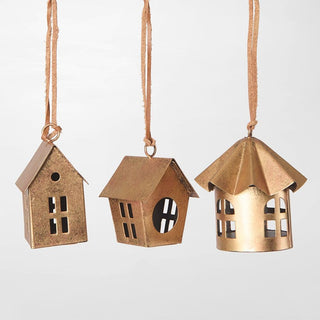 Three brass-colored hanging house-shaped ornaments on a white background
