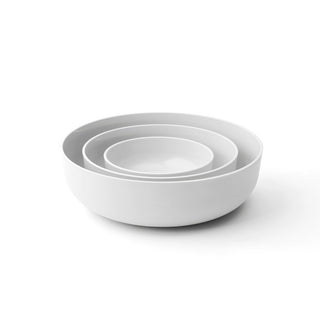 Set of three white ceramic bowls of different sizes on a white background