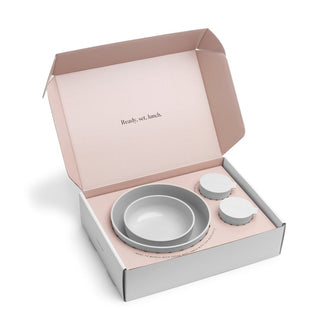 Set of gray bowls in a pink and white box with 'Ready, set, lunch.' text.