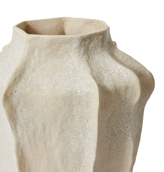 Beige ceramic vase with textured surface on a white background