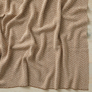 Textured fabric with a herringbone pattern on a wooden surface