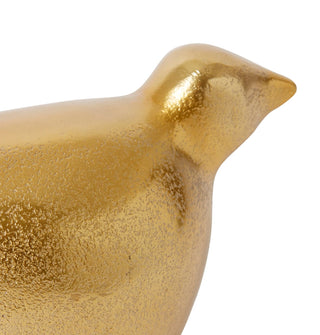 Gold bird-shaped decorative object on a white background