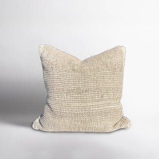 Textured beige pillow on a light gray background