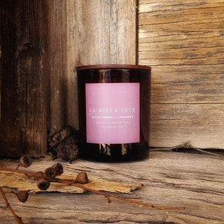 Candle with a pink label on a wooden surface