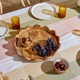 Wooden tray with fruits on a checkered tablecloth