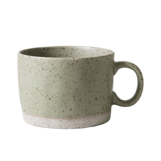 Speckled green mug on a white background
