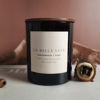 Black candle with 'La Bella Luce' label on a neutral background