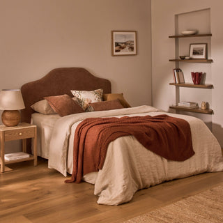 Bedroom with a bed, nightstands, and shelves with decor items.