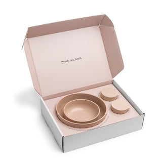 Set of beige ceramic bowls in a box with 'Ready, set, lunch.' text on a white background