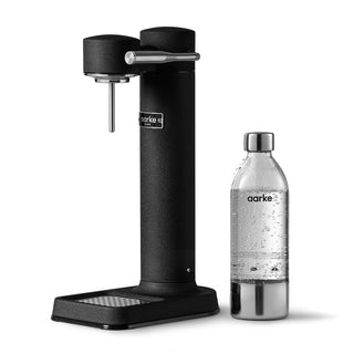 Black aarke soda maker with a silver bottle on a white background