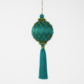 Decorative teal ornament with gold lattice pattern and tassel on a white background