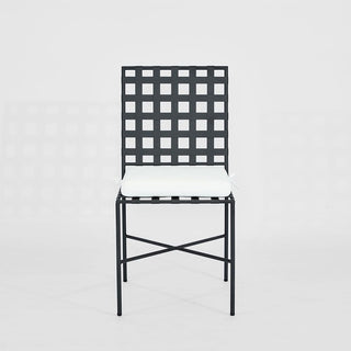 Black metal chair with white cushion on a light gray background