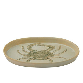 Round ceramic tray with a crab design on a white background