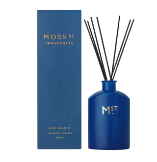 Blue fragrance diffuser with sticks and packaging labeled 'Moss St. Fragrances' on a white background