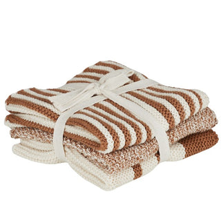 Stack of brown and white striped towels tied together on a white background
