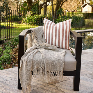 Chair with striped pillow and blanket on a patio