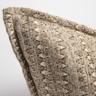 Close-up of a textured beige fabric with a subtle pattern on a light gray background