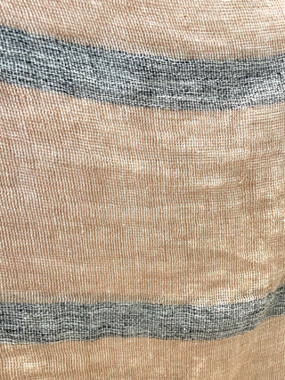 Close-up of striped fabric with beige, blue, and gray colors.