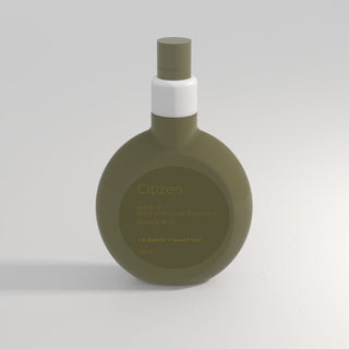 Green perfume bottle with white cap on a light gray background