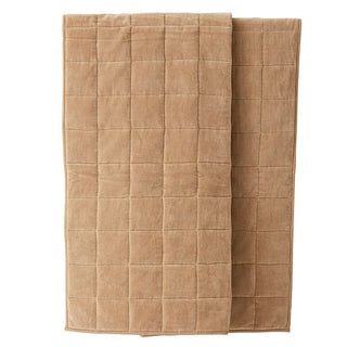 Beige quilted blanket on a white background