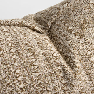 Close-up of textured beige fabric with a subtle pattern