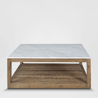 Coffee table with marble top and wooden base on a white background