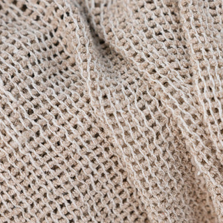 Close-up of beige knitted fabric texture