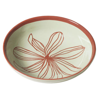 Ceramic bowl with red floral design on a white background