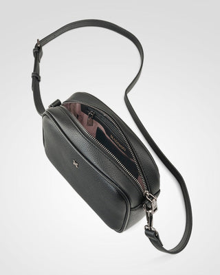 Black leather crossbody bag on a light gray background