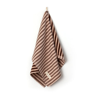 Striped towel with a brand label on a white background