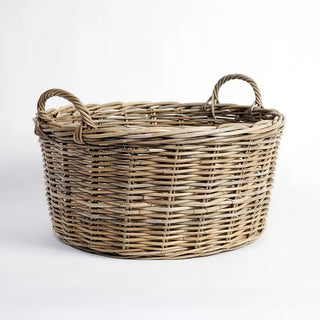 Wicker basket with handles on a white background