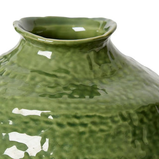 Close-up of a textured green ceramic vase on a white background