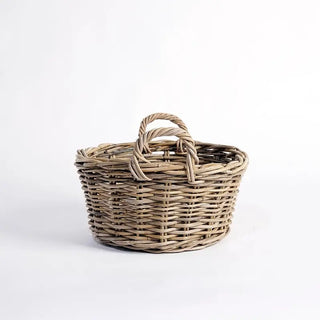 Wicker basket with handle on a white background