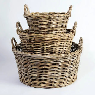 Set of three woven baskets of different sizes on a white background