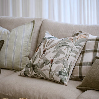 Decorative pillows on a beige sofa with a neutral background