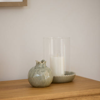 Clear glass with decorative green base on a white backgroundsurface.