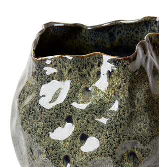 Ceramic vase with textured surface and white speckles on a white background