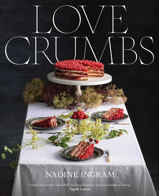 Book cover of 'Love Crumbs' by Nadine Ingram with a table setting and cake.