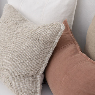 Close-up of textured pillows on a neutral background