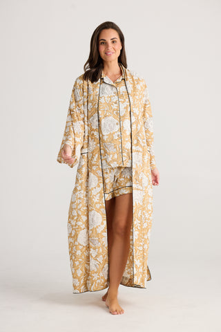Woman wearing a floral kimono-style robe and pajama set on a white background