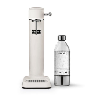 Aarke sparkling water dispenser and bottle on a white background