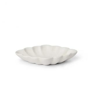 White ceramic shell-shaped dish on a white background