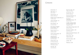 Tabletop with books and decor items, featuring a framed black and white photo of a woman.