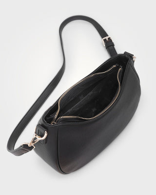 Black handbag with a strap on a white background