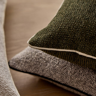 Close-up of two textured pillows on a wooden surface