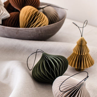 Decorative paper ornaments in various colors on a light surface.