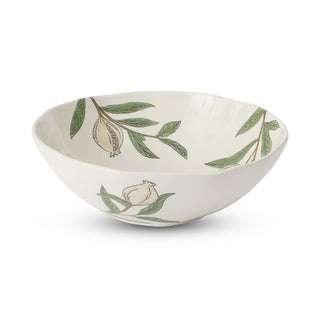 White ceramic bowl with green leaf and white flower patterns on a white background