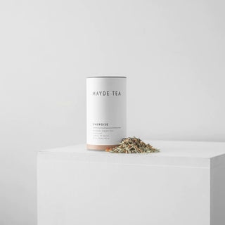Mayde Tea Energise canister with tea leaves on a white surface and background